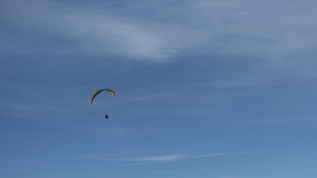 paragliding on blue skyの写真素材