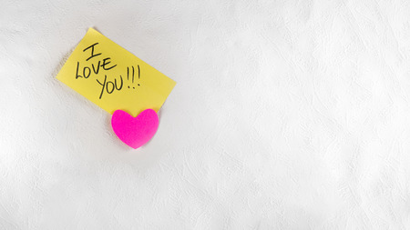 Valentines day. Sticked love message on a white wallの写真素材