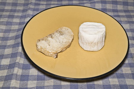 Organic goat cheese and slice of breadの写真素材