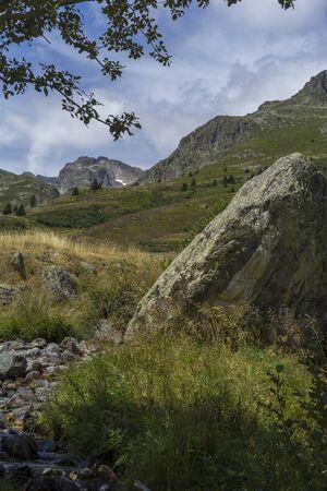 Mountains, fields and torrent. French Alpsの写真素材