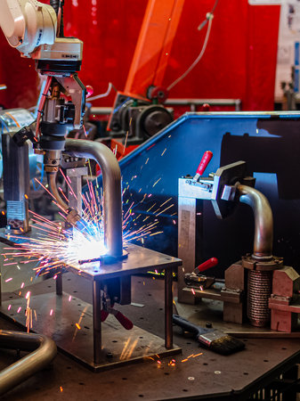 Industrial welding robots represent the movement in the automotive parts industry.