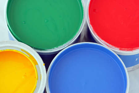 Vertical picture of paints in red,blue,green and yellow on white