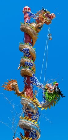 Colorful chinese style dragon statue in shrine with lamp and lucky bamboo at Ayuthaya Thailandの写真素材