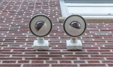 Security cameras, Two CCTV on the brick wall of building
