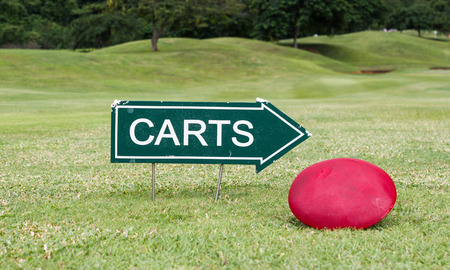 The golf carts sign on a golf field, for the directionの写真素材