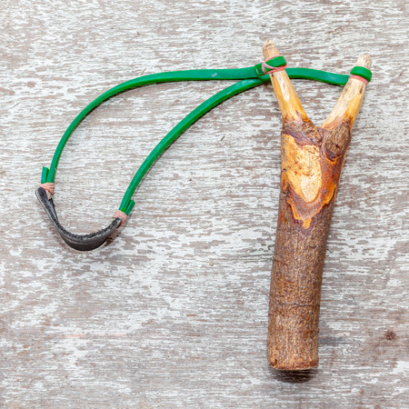 The old slingshot on old wood background