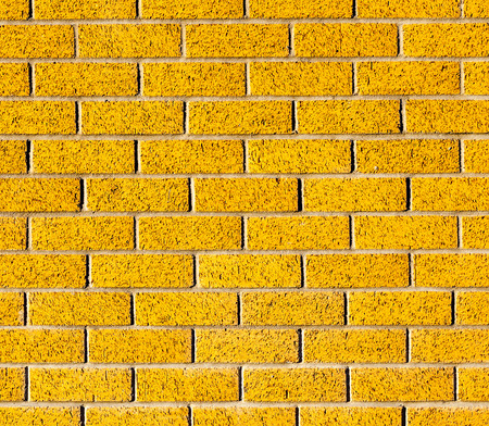 The yellow brick wall texture and little black spot, use as background.の写真素材