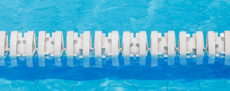 Closeup of white lane rope in swimming pool for sport competitions.の写真素材