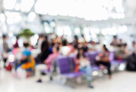 Blurred background of the passenger waiting the flight in airport boarding gate. Unrecognizable faces, bleached effect.の写真素材