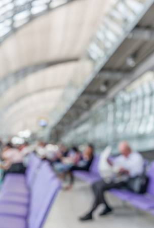 Blurred image of a man read newspaper while waiting the flight in departure lounge of Airport.の写真素材