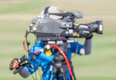 Blurred image of a man is recording VDO during golf tournament in golf course.の写真素材