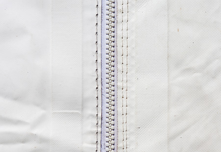 Close up shot of zipper and sewing on white background tent.の写真素材