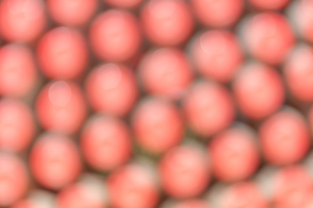 Abstract blurred background of closeup the red bottle caps arrangement.