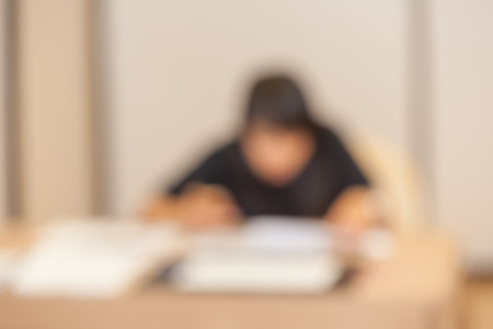 Blurred photo of women staff at registration desk in front of hotel meeting room.の写真素材