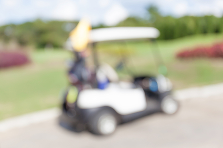 Blurred photo of golf cart parks around golf course service standby for golfers.の写真素材