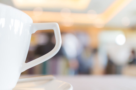 Focus on the white tea cup with blurred background of conference breaking time.の写真素材
