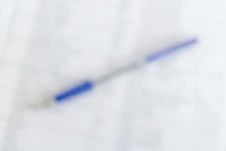 Abstract blurred background of pen on notepad, business concept.の写真素材