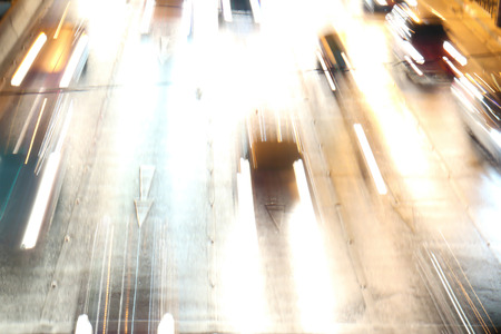 Abstract blurred background of scenic fast cars on night street.