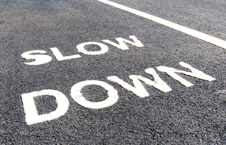 Close up slow down marking on street, for warning the drivers to reduce speed.の写真素材