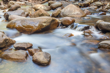 Natural rocks over the flowing clear water.の写真素材