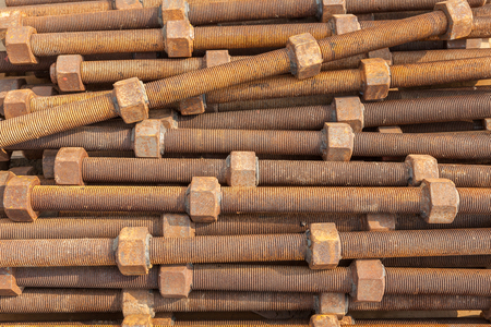 Close-up pile of old rusty screw nuts and bolts use for heavy industrial usage.
