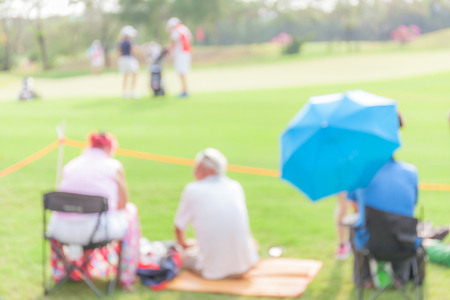 Blurred photo of unidentified people are looking the match in golf tournament.の写真素材