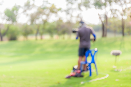 Blurred photo of Photographer on duty in golf tournament live broadcasting.の写真素材