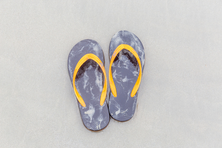 Brown flip-flops on sandy ocean beach, summer and vacation concept.の写真素材