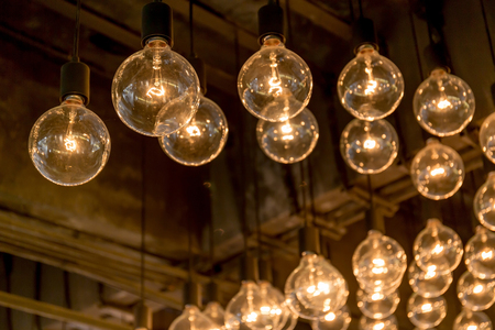 Group of Edison light bulbs hanged decoration from ceiling in department store.の写真素材