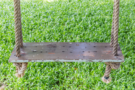 Close-up the wooden swing hanging on tree in the garden, relaxation concept.の写真素材