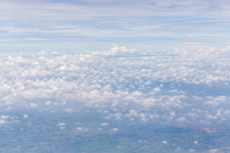 Texture and layer of white fluffy clouds spread on blue sky background.の写真素材