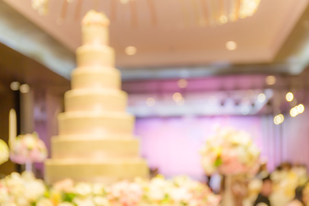 Abstract blurred photo of luxury wedding cakes standing decorated in wedding ceremony party.の写真素材