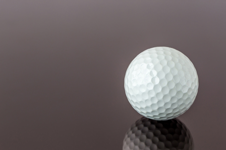 Close up the new white golf ball with the reflection, sport concept.の写真素材