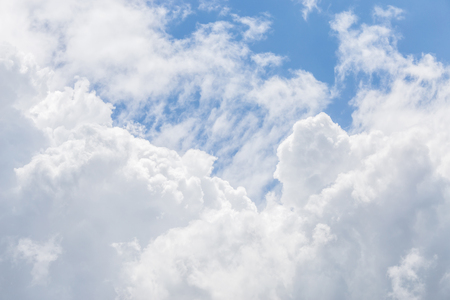 Beautiful fluffy white cumulus clouds on blue sky background.の写真素材