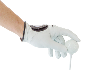 Close up the golfer hand in glove holding the golf ball with tee ready to start the golf game.の写真素材