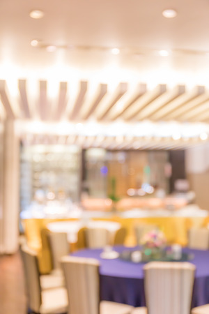 Abstract blurred photo of empty round dining table setting prepare for clients in restaurant.の写真素材