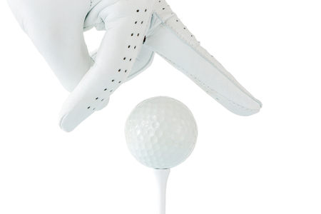 Golfer use two fingers holding golf ball on tee with white background, sport golf concept.の写真素材