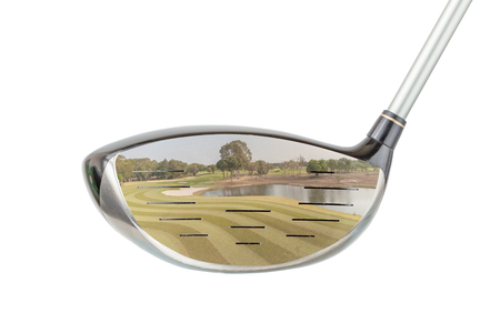 Golf concept, the shiny metal golf driver club and green golf course panoramic view inside with white background.の写真素材