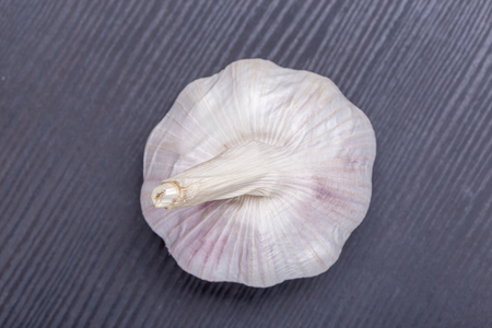 Top view of white and fresh raw garlic bulbs place on wooden table, valuable herbal for healthiness.の写真素材