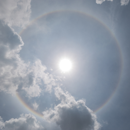 The sun halo (optical phenomena) with cloudy sky in background, natural phenomenon.の写真素材