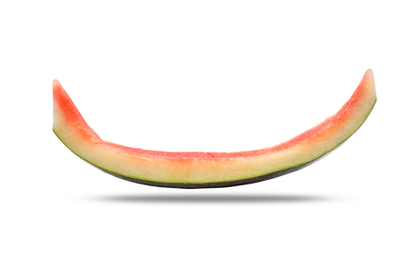 Slice of watermelon rind after eaten up on the white background and the shadow below.の写真素材