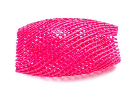 Blank covered pink foam net for fruits protection isolated on white background.の写真素材