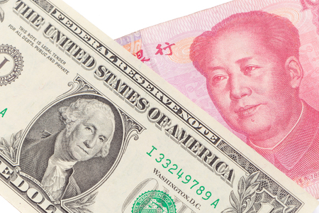 US dollar bill and Chinese yuan banknote on white background, USA and Chinese exchange rate concept.の写真素材