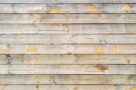 Horizontal striped wooden planks wall surface backgroundの写真素材