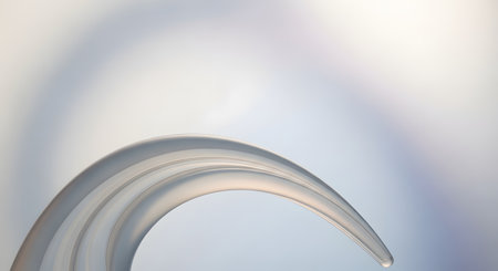 An elegant and minimalist abstract background featuring a smooth, curved shape made of translucent or frosted glass. The soft, gentle light and subtle shadows create a clean, serene, and sophisticated atmosphere. This image is ideal for use as a calming wallpaper or a backdrop for product placement.の素材