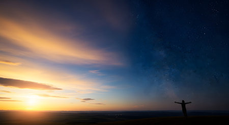 A stunning composite landscape showing the transition from a golden sunset to a starry night sky with the Milky Way. A lone silhouette of a person stands with arms outstretched in celebration, embracing the beauty and duality of day and night.の素材