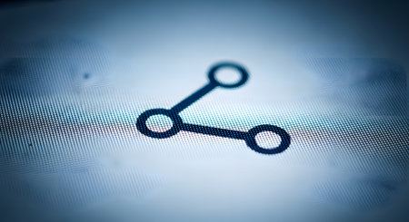 An extreme macro photograph of a 'share' icon on a digital screen, showing the individual pixels. The blue and white image symbolizes social media, networking, connection, and sharing content online.の素材