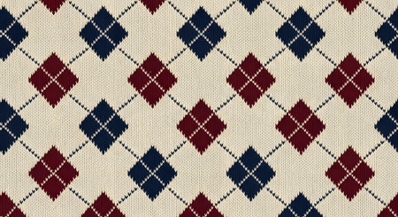 A seamless, close-up texture of a classic argyle knitted fabric. The pattern features interlocking diamonds in dark blue and maroon red on a cream-colored wool background, creating a traditional and cozy textile design.の素材