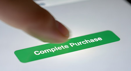 A close-up shot of a finger about to tap a green 'Complete Purchase' button on a digital screen. This image illustrates the final step of an online transaction, representing e-commerce, internet shopping, and digital payment.の素材