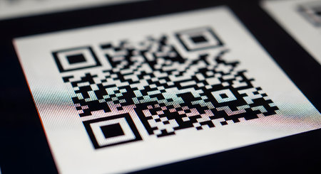 An extreme close-up, macro photograph of a QR (Quick Response) code displayed on a digital screen. The individual pixels of the screen are visible, emphasizing the digital nature of the code. This represents technology, data, scanning, mobile payment, and information access.の素材